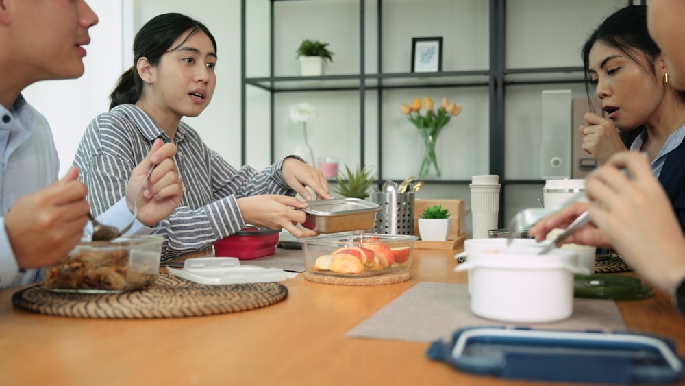 Various types of corporate lunch boxes neatly arranged with diverse food options.