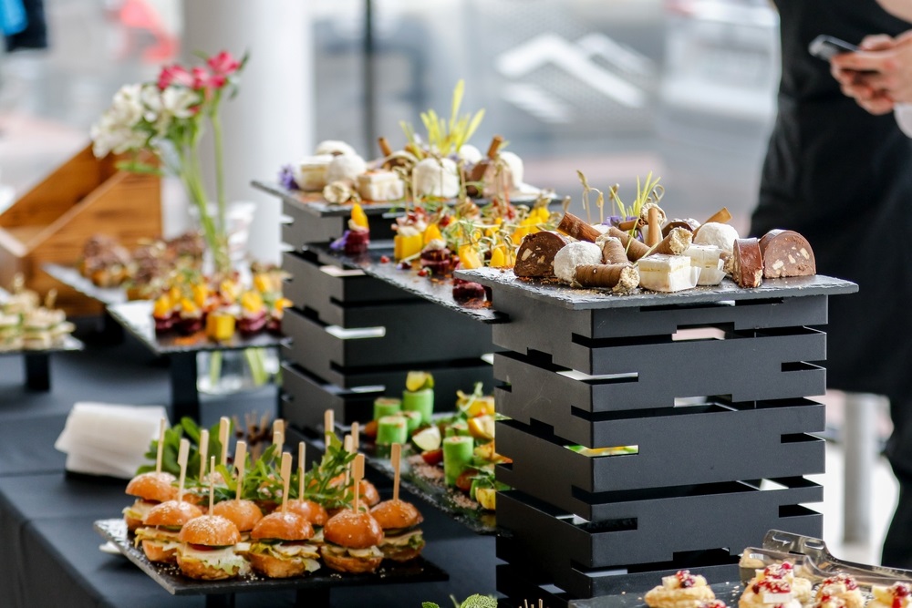 Colleagues enjoying a well-decorated office food party with diverse dishes.