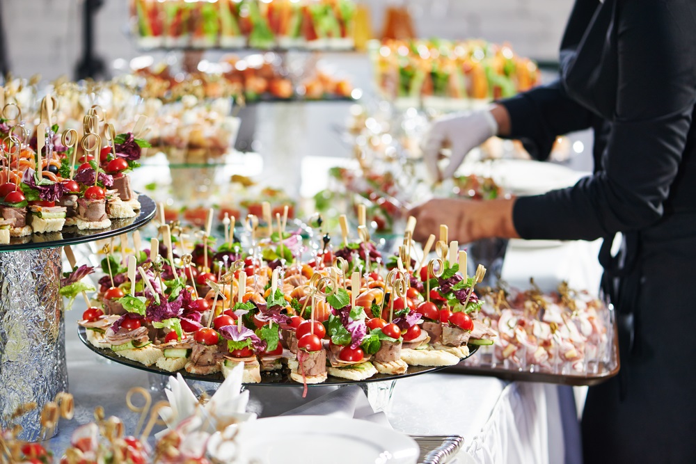 Colleagues enjoying a well-decorated office food party with diverse dishes.