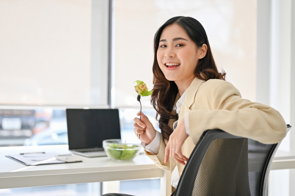 A selection of the most popular catering options for work lunches in 2025, featuring eco-friendly packaging, fresh salads, and global cuisine.