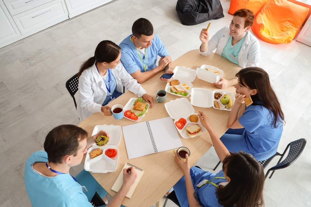 A team enjoying a variety of healthy, catered staff lunch options.